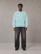 Model wearing the SM London Sweatshirt in Ice Blue, front view.