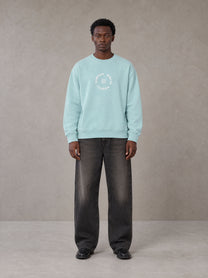 Model wearing the SM London Sweatshirt in Ice Blue, front view.