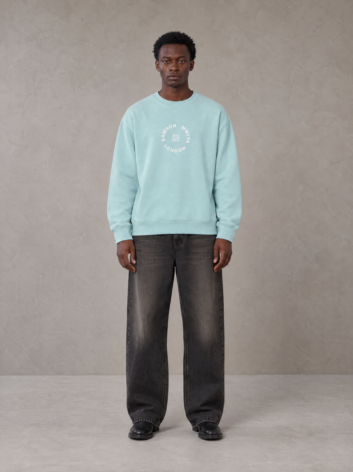 Model wearing the SM London Sweatshirt in Ice Blue, front view.