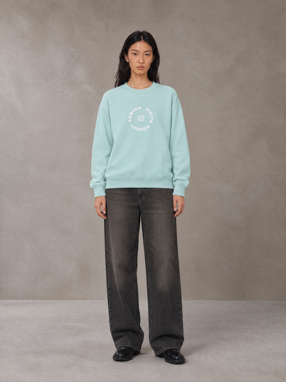 Model wearing the SM London Sweatshirt in Ice Blue, front view.