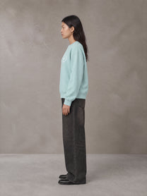 Model wearing the SM London Sweatshirt in Ice Blue, side profile.