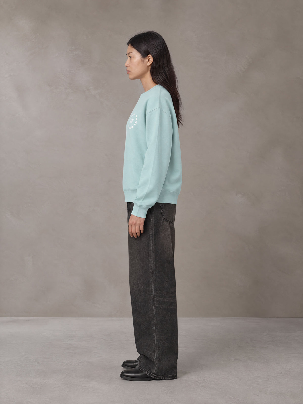 Model wearing the SM London Sweatshirt in Ice Blue, side profile.
