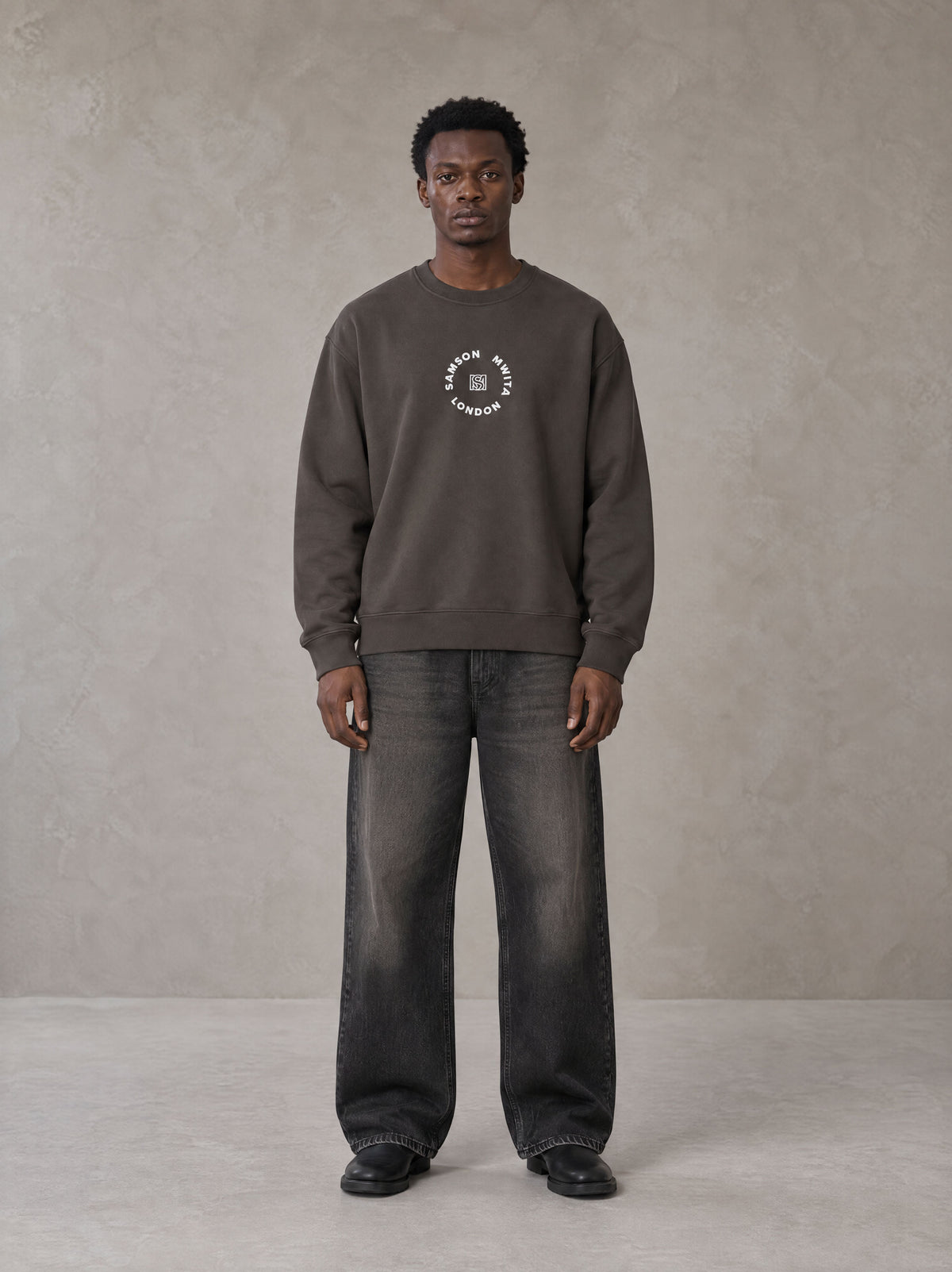 Model wearing the SM London Sweatshirt in Kabul Brown, front view.