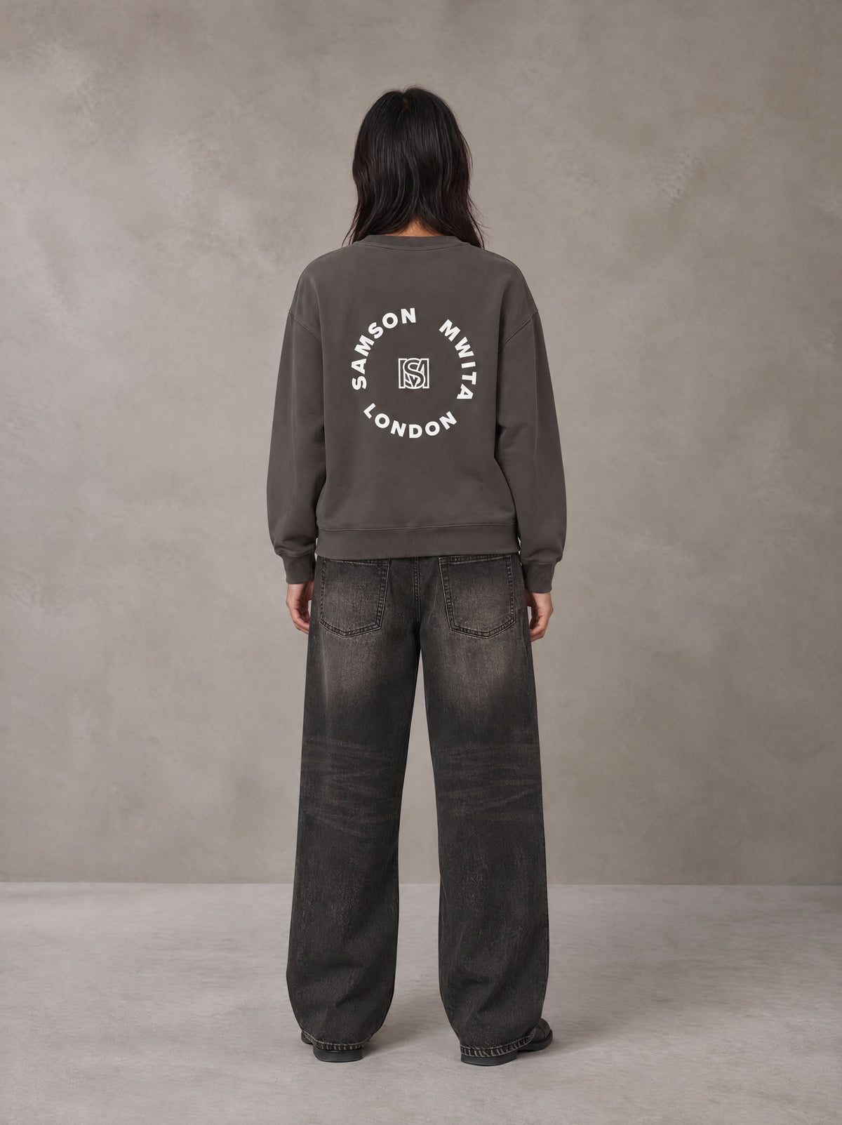 Model wearing the SM London Sweatshirt in Kabul Brown, rear view.
