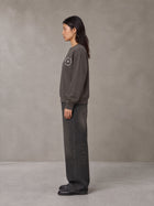 Model wearing the SM London Sweatshirt in Kabul Brown, side profile.