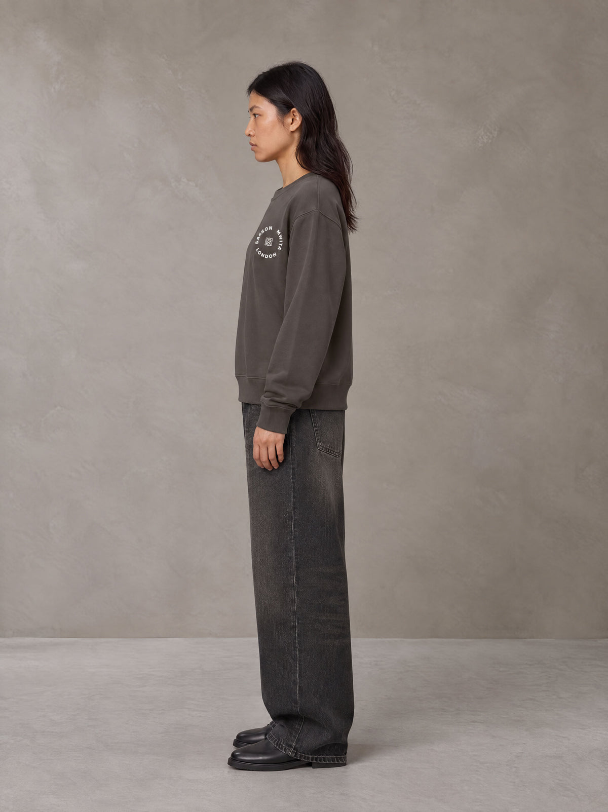 Model wearing the SM London Sweatshirt in Kabul Brown, side profile.