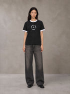 Model wearing the SM London T-shirt in Midnight Black, front view.