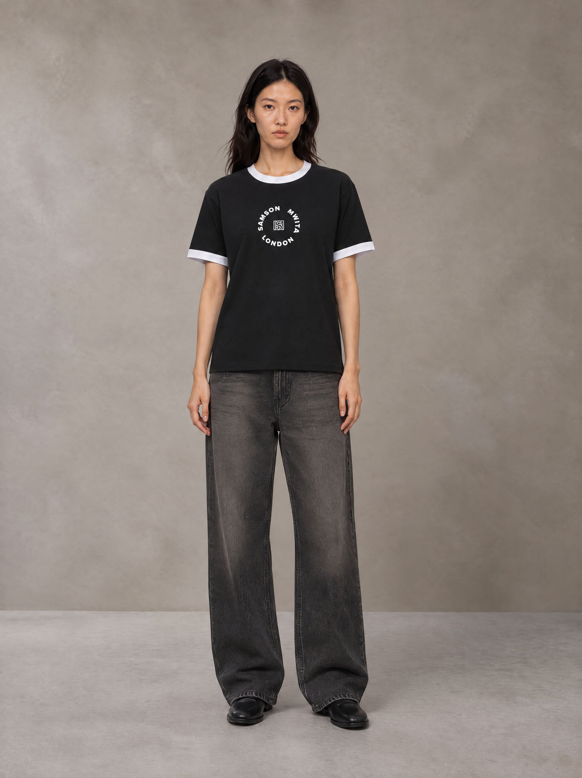 Model wearing the SM London T-shirt in Midnight Black, front view.