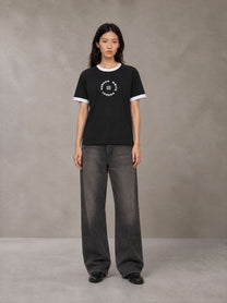 Model wearing the SM London T-shirt in Midnight Black, front view.