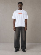 Model wearing the SM Block T-shirt in Lucent White, front view.