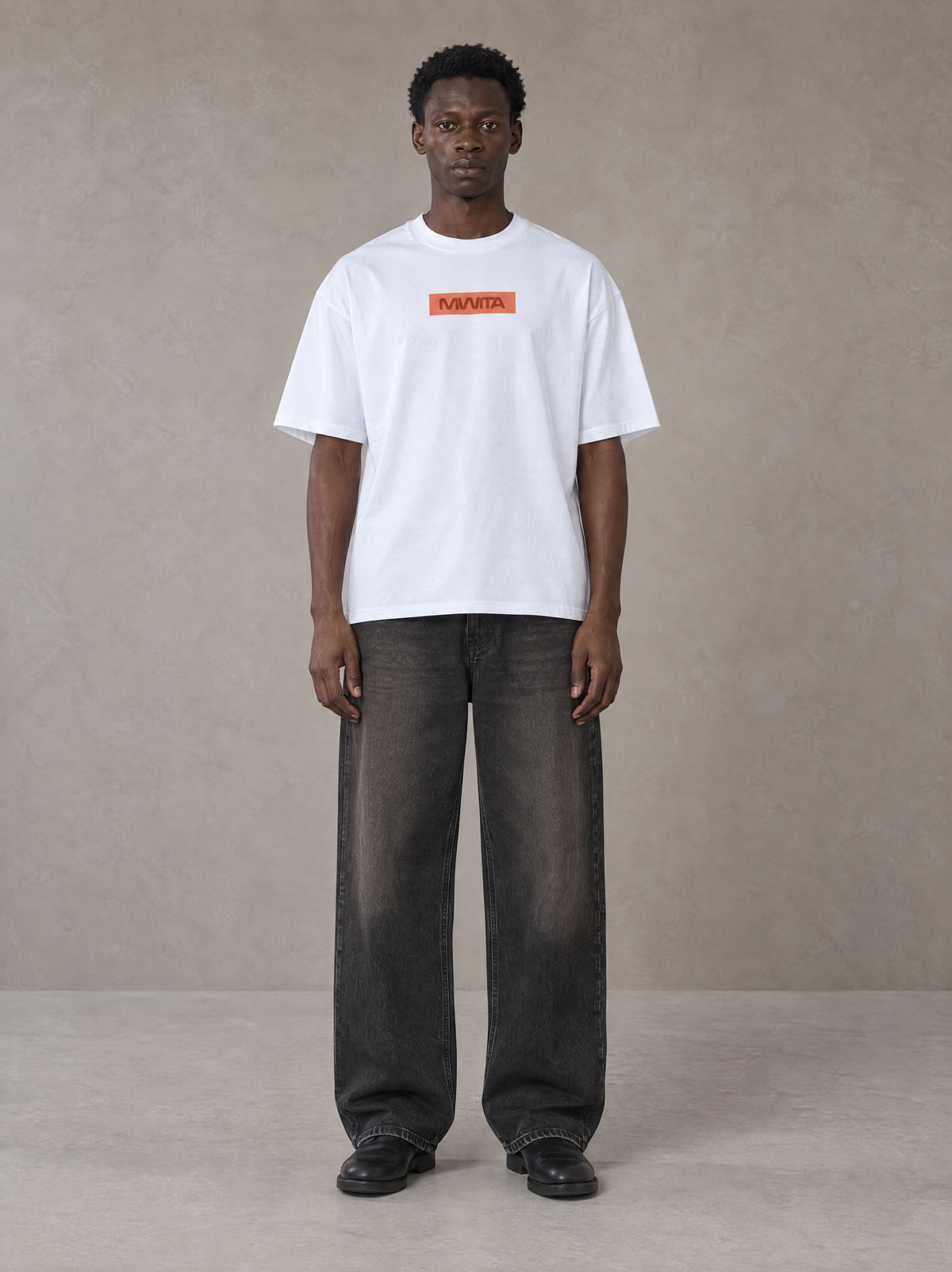 Model wearing the SM Block T-shirt in Lucent White, front view.