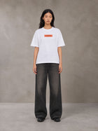 Model wearing the SM Block T-shirt in Lucent White, front view.
