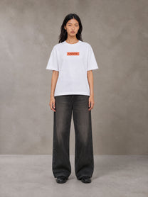 Model wearing the SM Block T-shirt in Lucent White, front view.