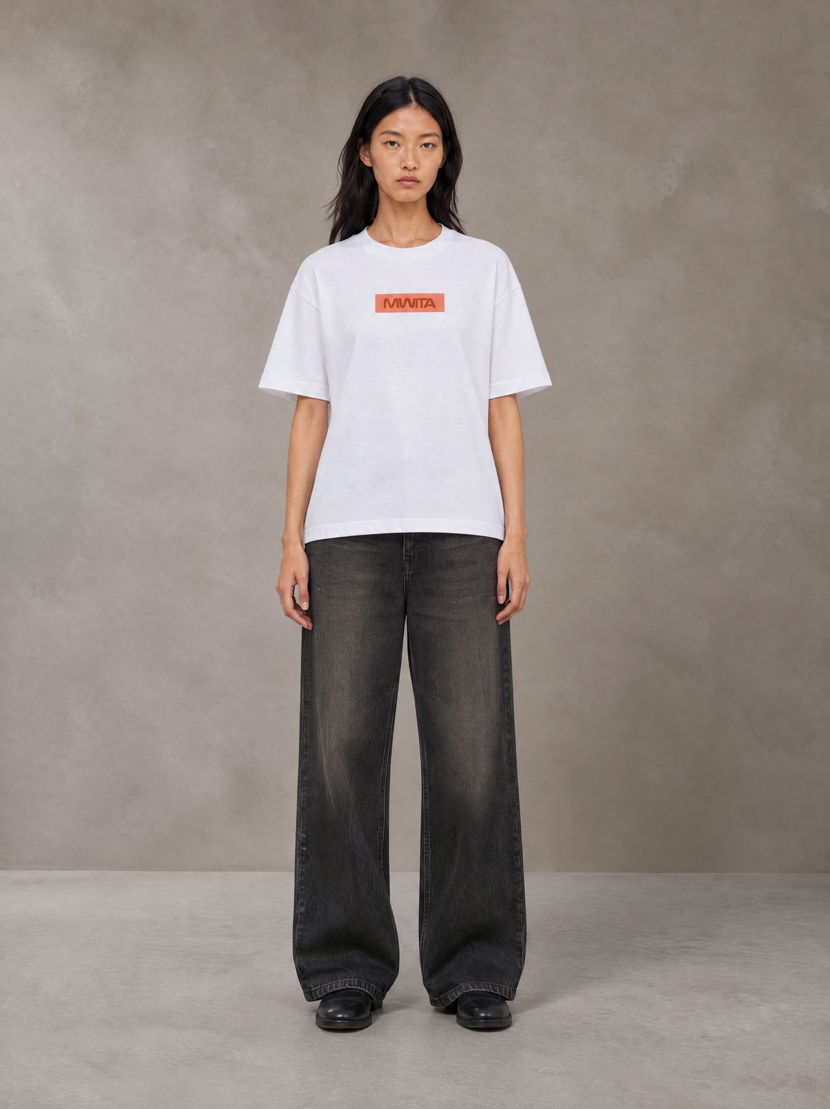 Model wearing the SM Block T-shirt in Lucent White, front view.