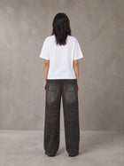 Model wearing the SM Block T-shirt in Lucent White, rear view.