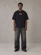 Model wearing the SM Block T-shirt in Midnight Black, front view.