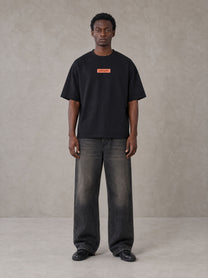 Model wearing the SM Block T-shirt in Midnight Black, front view.
