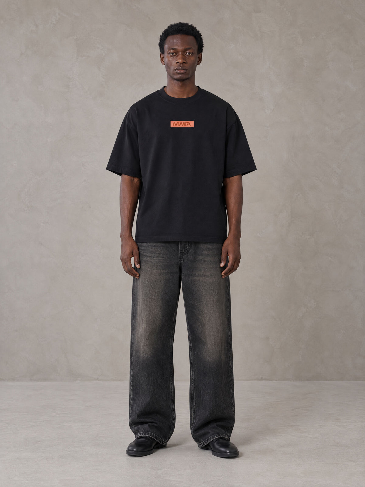 Model wearing the SM Block T-shirt in Midnight Black, front view.