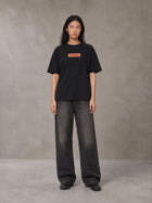 Model wearing the SM Block T-shirt in Midnight Black, front view.