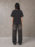 Model wearing the SM Block T-shirt in Midnight Black, rear view.