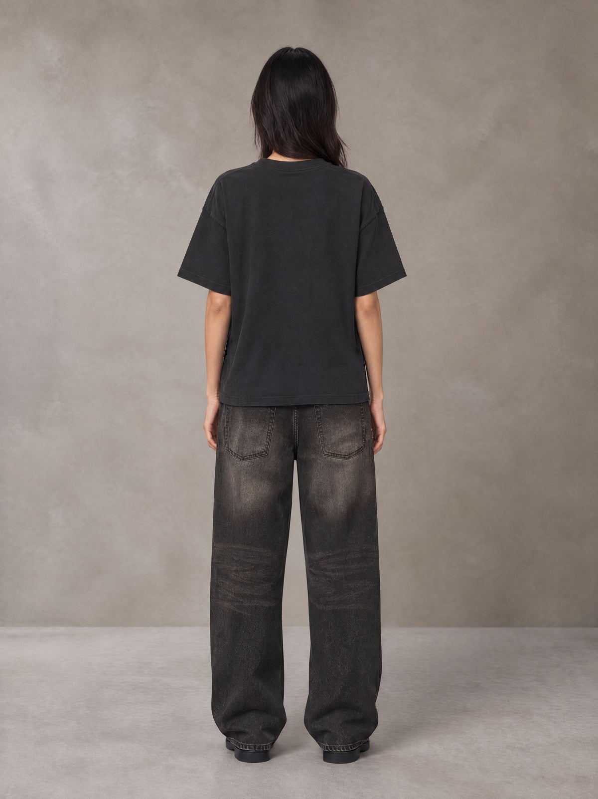 Model wearing the SM Block T-shirt in Midnight Black, rear view.