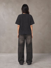 Model wearing the SM Block T-shirt in Midnight Black, rear view.