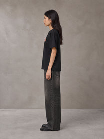 Model wearing the SM Block T-shirt in Midnight Black, side profile.