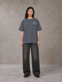 Model wearing the SM Carved Flight T-shirt in Chambray, front view.