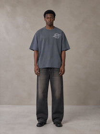 Model wearing the SM Carved Flight T-shirt in Chambray, front view.
