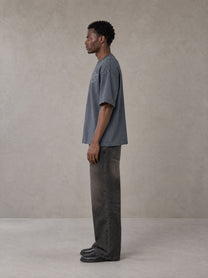 Model wearing the SM Carved Flight T-shirt in Chambray, side profile.