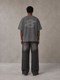 Model wearing the SM Carved Flight T-shirt in Deep Charcoal, rear view.