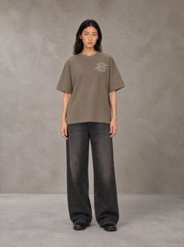 Model wearing the SM Carved Flight T-shirt in Kabul Brown, front view.