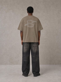 Model wearing the SM Carved Flight T-shirt in Kabul Brown, rear view.