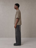 Model wearing the SM Carved Flight T-shirt in Kabul Brown, side profile.