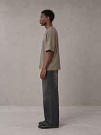Model wearing the SM Carved Flight T-shirt in Kabul Brown, side profile.