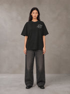 Model wearing the SM Carved Flight T-shirt in Midnight Black, front view.