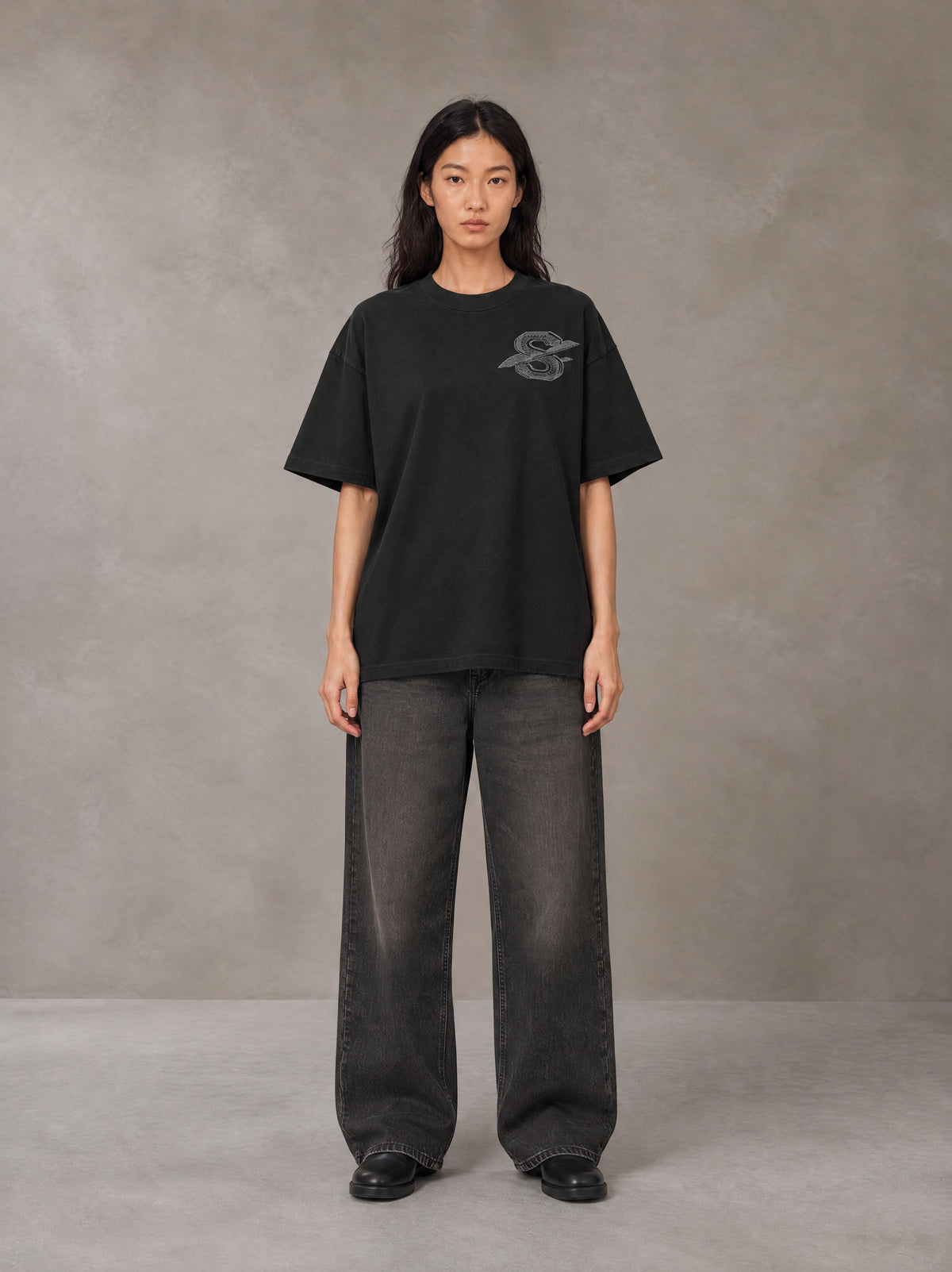 Model wearing the SM Carved Flight T-shirt in Midnight Black, front view.