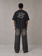 Model wearing the SM Carved Flight T-shirt in Midnight Black, rear view.