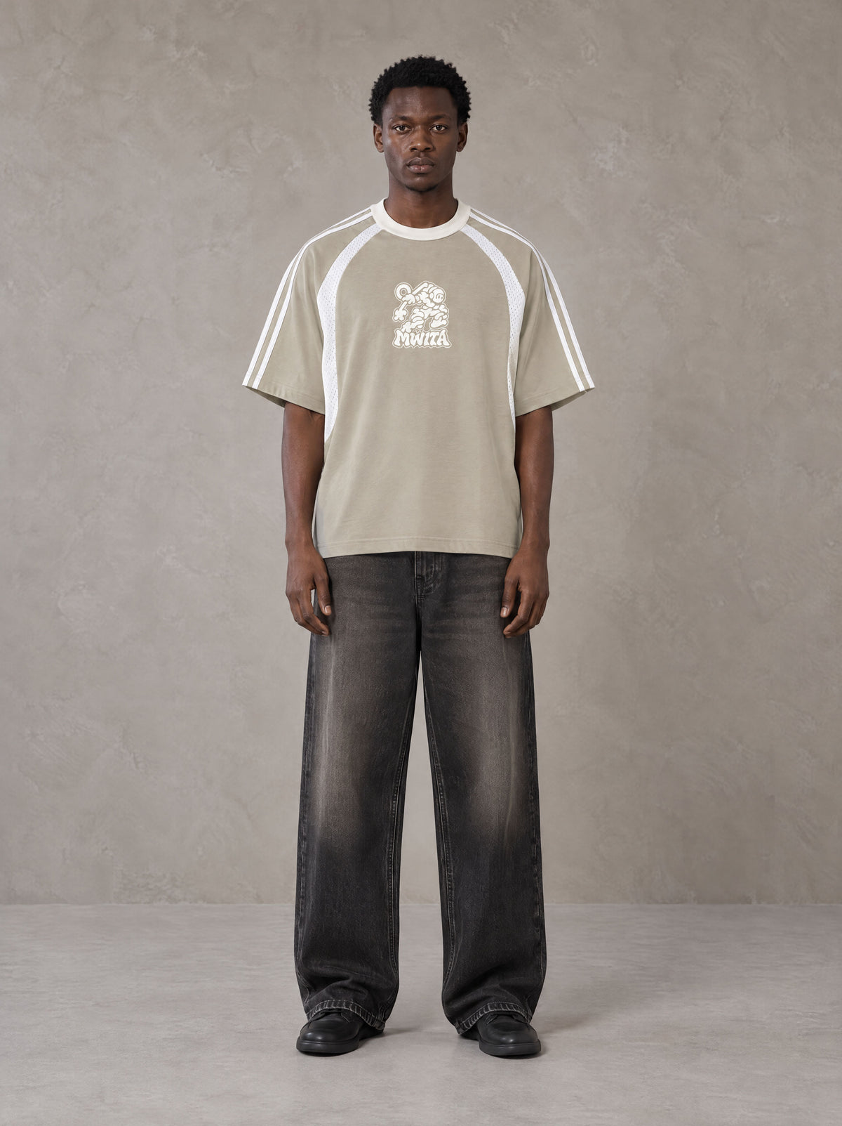 Model wearing the SM Cosmic Bloom T-shirt in Fine Sand, front view.