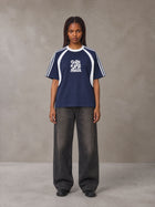 Model wearing the SM Cosmic Bloom T-shirt in Oxford Navy, front view.