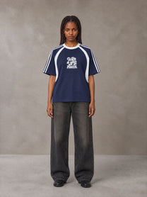 Model wearing the SM Cosmic Bloom T-shirt in Oxford Navy, front view.