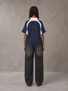 Model wearing the SM Cosmic Bloom T-shirt in Oxford Navy, rear view.