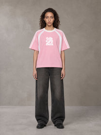 Model wearing the SM Cosmic Bloom T-shirt in Blossom, front view.