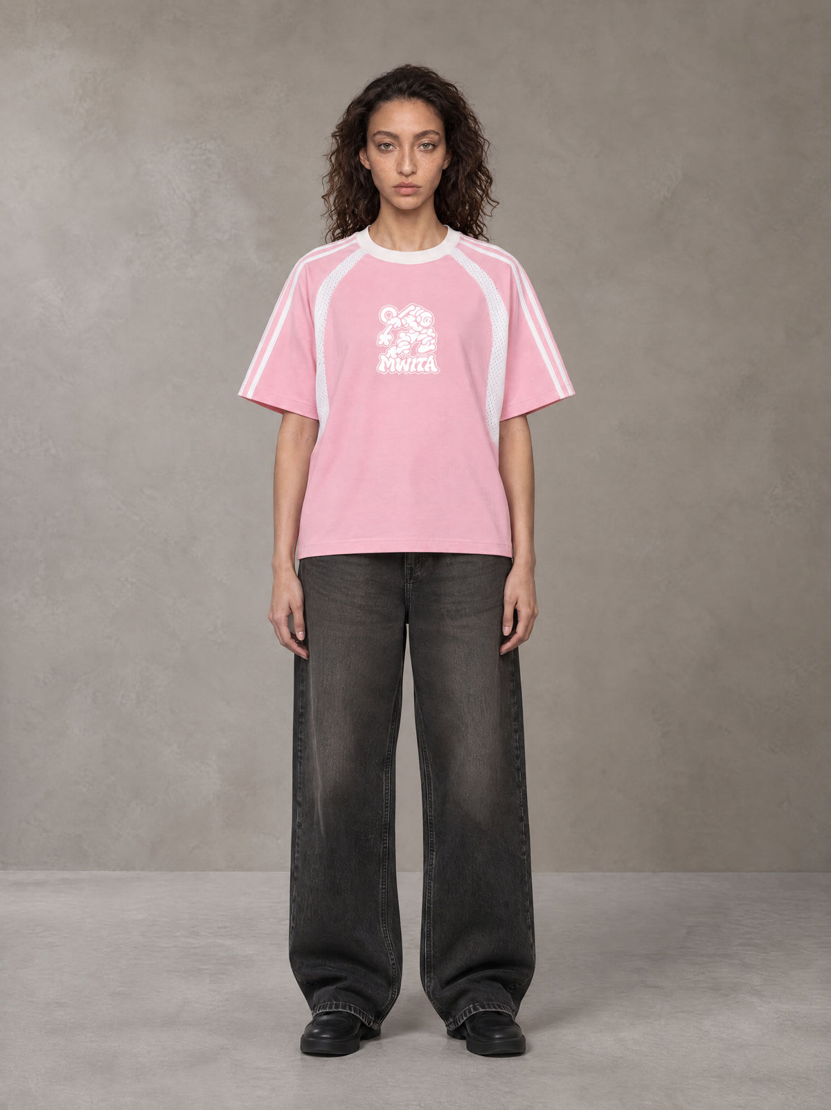 Model wearing the SM Cosmic Bloom T-shirt in Blossom, front view.