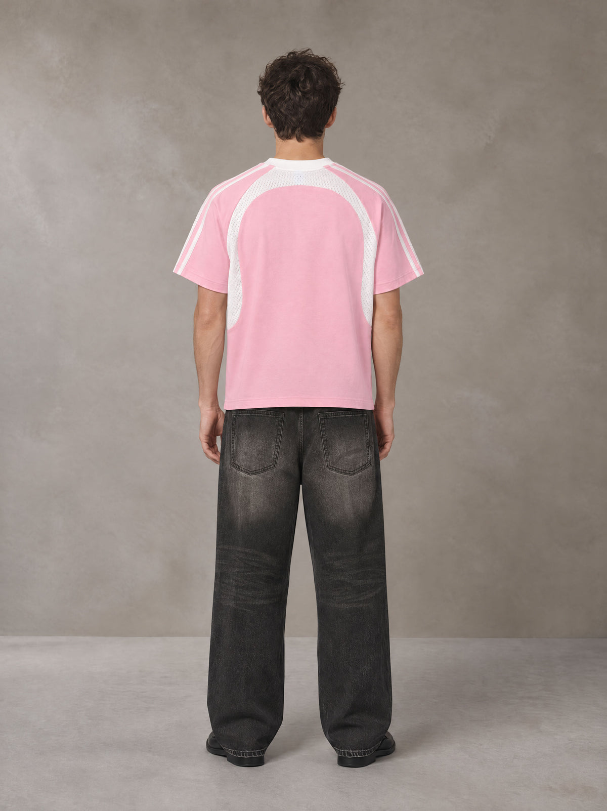 Model wearing the SM Cosmic Bloom T-shirt in Blossom, rear view.