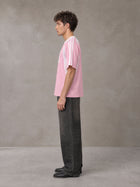 Model wearing the SM Cosmic Bloom T-shirt in Blossom, side profile.