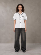 Model wearing the SM Dugout Atelier T-shirt in Lucent White, front view.