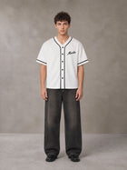 Model wearing the SM Dugout Atelier T-shirt in Lucent White, front view.