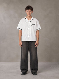 Model wearing the SM Dugout Atelier T-shirt in Lucent White, front view.