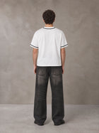 Model wearing the SM Dugout Atelier T-shirt in Lucent White, rear view.